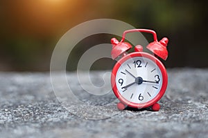 Red alarm clock. Prime time every second.Concept for business deadline, schedule and urgency.Red retro alarm bell clock on old