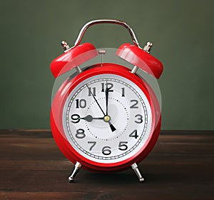 The red alarm clock showing 9-00 hours.