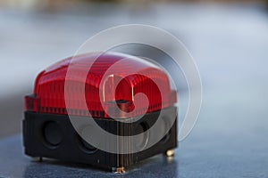 A red alarm light that flashes when there is a danger