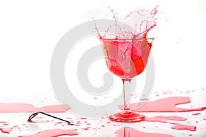 Red alcohol cocktail drink splash on white background.