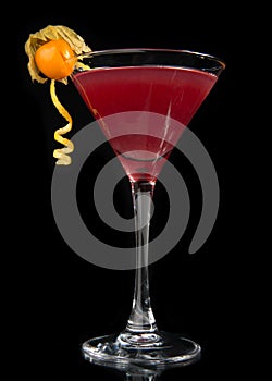 Red alcohol cosmopolitan cocktail on black background