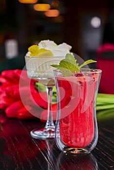 Red alcohol raspberry cocktail and Pina Colada served in a unique design glasses