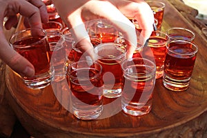 Red alcohol tincture on a wooden tray. Catering with alcohol