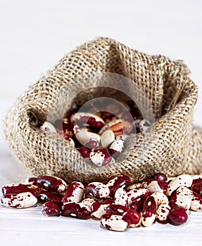 Red Anasazi beans In a bag on a white background. Haricot in a sack.Vertical orientation.