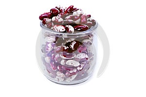 Red Anasazi Beans in a glass jar isolated on a white background. Spotted beans.Kidney beans.Haricot beans. Vegetarian food.