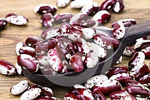 Red Anasazi Beans isolated on a wooden background. Spotted beans.Kidney beans.Haricot beans. Vegetarian food. Healthy protein food