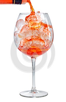 Red aperitif pouring into glass photo