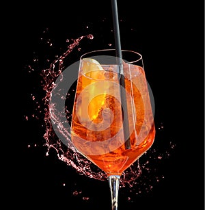 Red aperitif with straw and splash of water- red aperitif with straw and splash of water