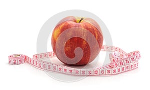 Red apple with a centimeter tape