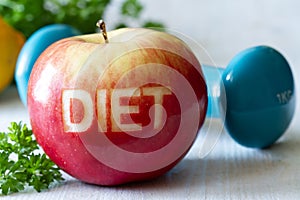 Red apple with cut-out word diet and dumbbell, diet and healthy lifestyle concept