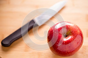 Red apple on cutting board