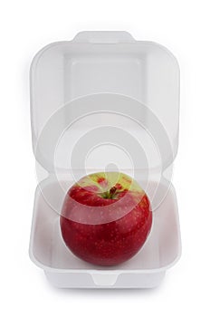 Red apple in a fast food packaging on white background