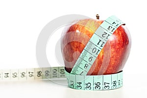 Red apple fitnes concept with centimeter.