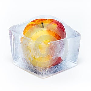 Red apple frozen in the ice cube