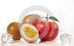 Red apple fruit with green leaf with half cut  passion fruit  on white.