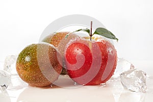 Red apple fruit with green leaf with passion fruit  on white.