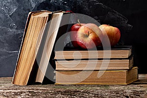 Back to school, Red Apple fruits on top of Book on Stack of Books with chalk board