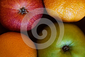 Red apple, green apple and two oranges in composition