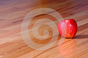 Red Apple on Hardwood Floor