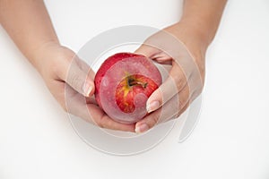 Top view of female hands holding red apple isolated on white