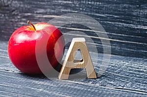 Red apple and letter A. The concept of primary education. Apple