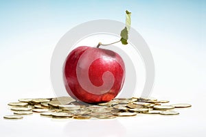 Red apple and a lot of golden coin