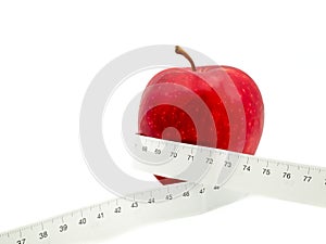 Red apple and measure tape centimeter that represent reduce weight or diet food and exercise for body good shape design concept