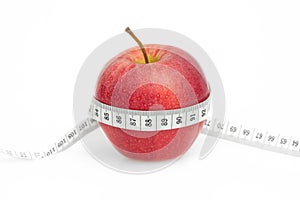 Red Apple with measure tape on white
