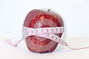 Red apple and measurement tape