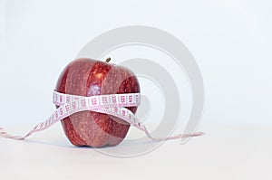 Red apple and measurement tape