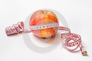 Red apple with measuring tape - diet concept