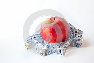 Red Apple and measuring tape on white background. Diet concept