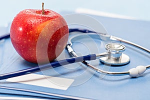 Red apple and medical stethoscope heathcare