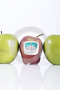 Red apple in the middle of green apple with measurement meter