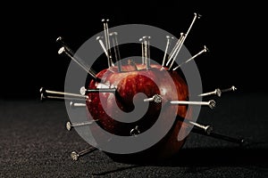 A red apple and nails on it