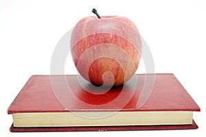 Red apple on notebook isolated on white background