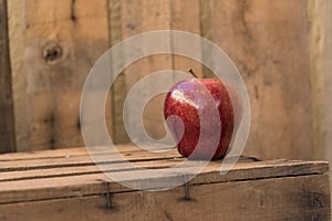 Red apple on an old wooden table photo