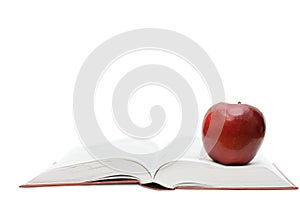 Red apple on the open book