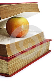 Red apple in between pages of old book