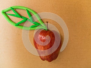 Red apple with Plasticine green leaf