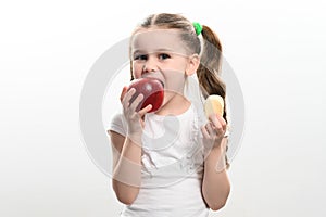 Red apple and potato chips, healthy and unhealthy food for children, little girl makes a choice between healthy and