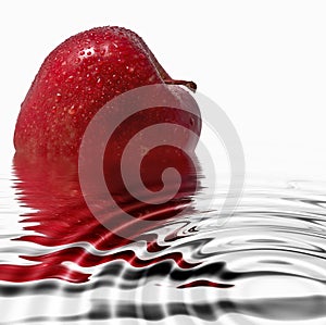 Red apple reflecting in the water