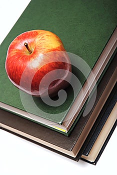 Red apple on stack of book