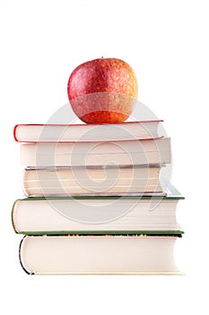 Red apple on a stack of books