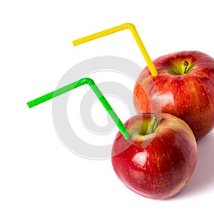 Red apple with a straw for a cocktail on a white background.