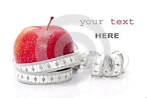 Red apple and tape measure