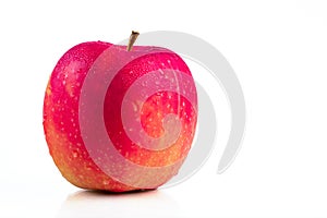 A red apple with water drops on skin on white background with copy space. Healthy fruit and healthy food concept. Vegan