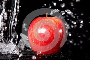 Red apple in water splash