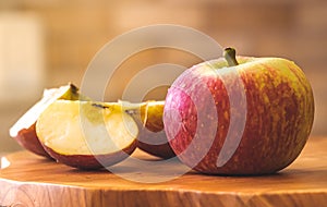 Red apple on the wood object.