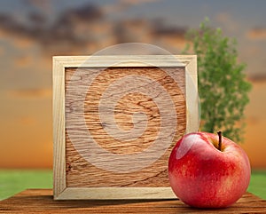 Red apple with wooden frame